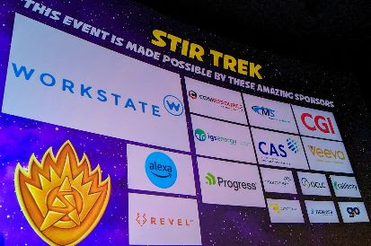 Photo of the projection screen with sponsor logos displayed